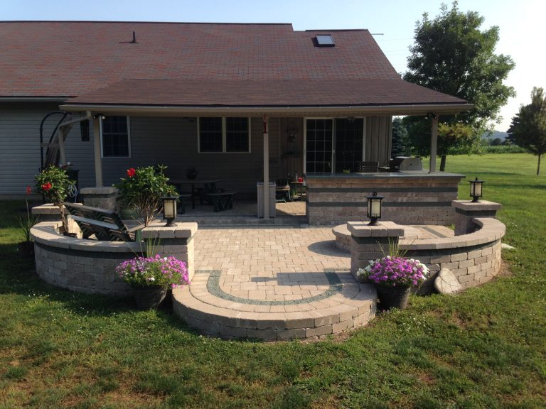 Inspiration for a large craftsman backyard brick patio kitchen remodel in Cleveland with a roof extension