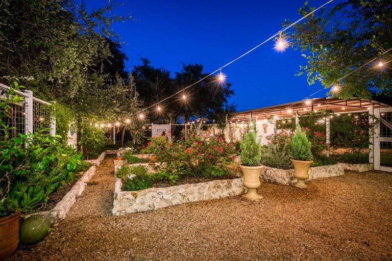 Inspiration for a large farmhouse full sun backyard mulch formal garden in Austin.