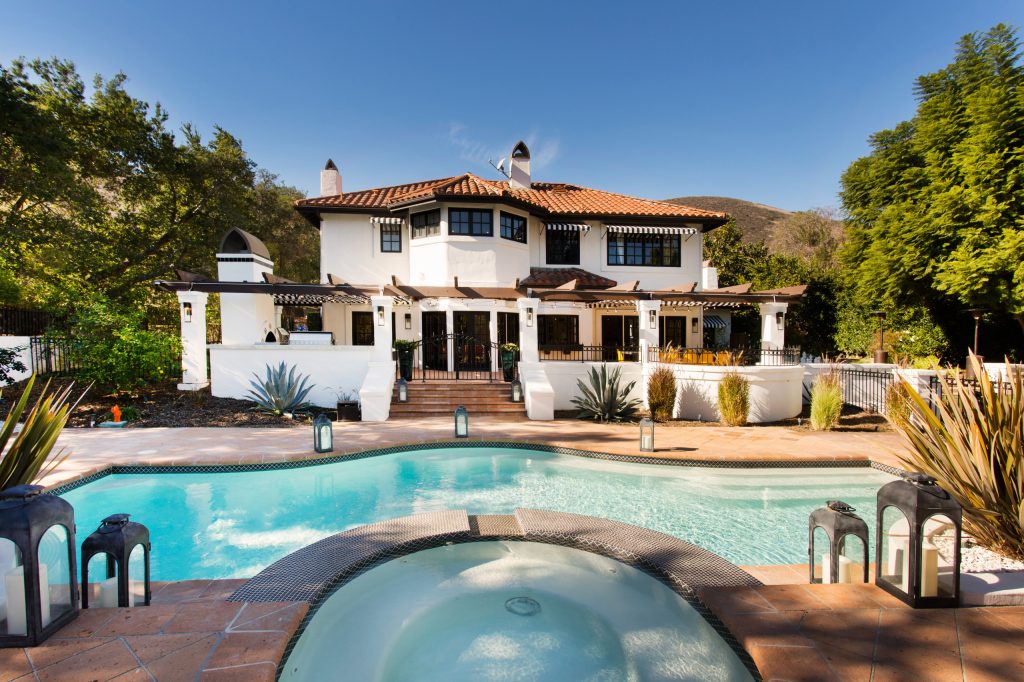 Inspiration for a large mediterranean backyard tile and custom-shaped lap hot tub remodel in Los Angeles