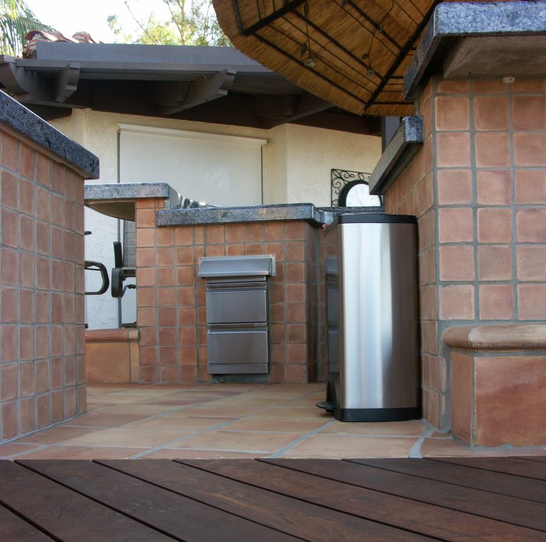 Inspiration for a large mediterranean backyard tile patio kitchen remodel in Orange County with a gazebo