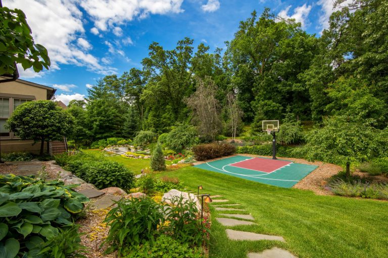 Inspiration for a large mediterranean partial sun backyard stone landscaping in Minneapolis for summer.