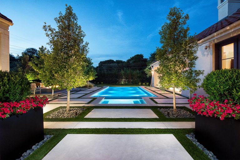 Inspiration for a large modern backyard concrete and rectangular infinity pool remodel in Dallas