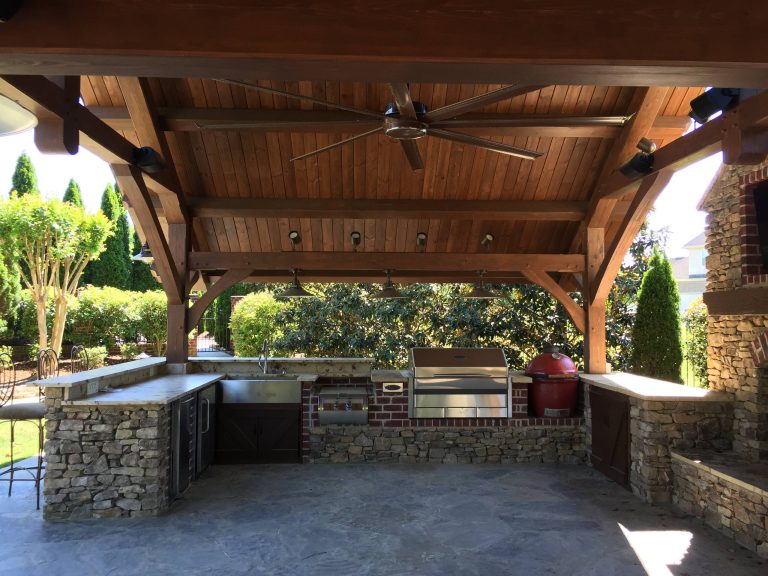 Inspiration for a large modern backyard concrete paver patio kitchen remodel in Other with a gazebo