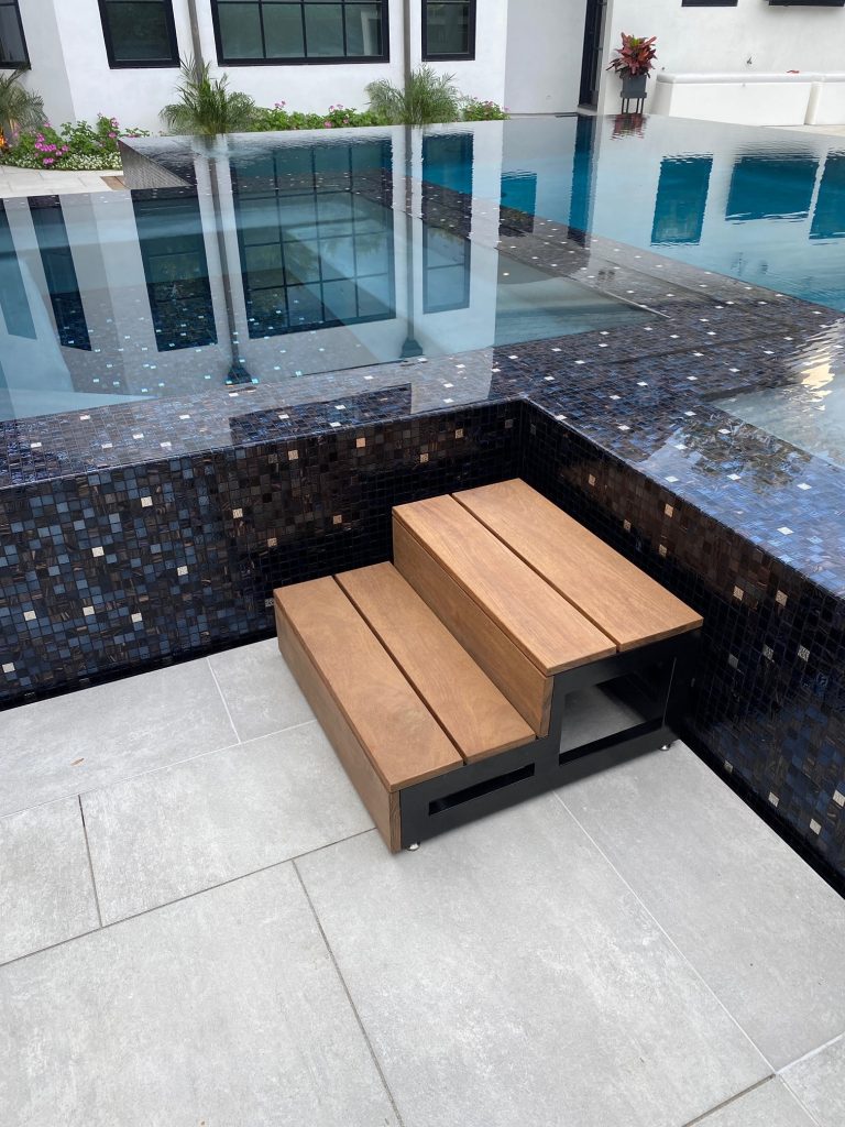 Inspiration for a large modern backyard tile and rectangular infinity pool landscaping remodel in Orange County