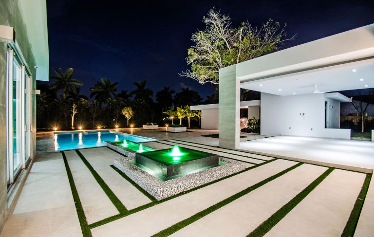Inspiration for a large modern backyard tile and rectangular lap pool fountain remodel in Miami