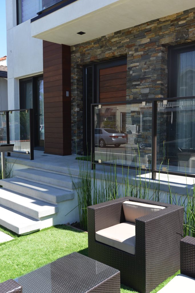 Inspiration for a large modern concrete front porch remodel in Los Angeles with a roof extension by Novum Architecture | Outdoor Photos | Porch | Landscaping | Landscape Design | Outdoor Living Space | Porch Design Ideas | Outdoor Living Space Ideas | Backyard Design