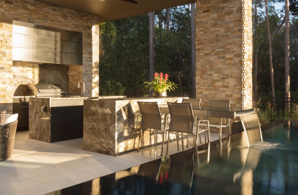 Inspiration for a large modern courtyard tile patio kitchen remodel in Orlando with a roof extension