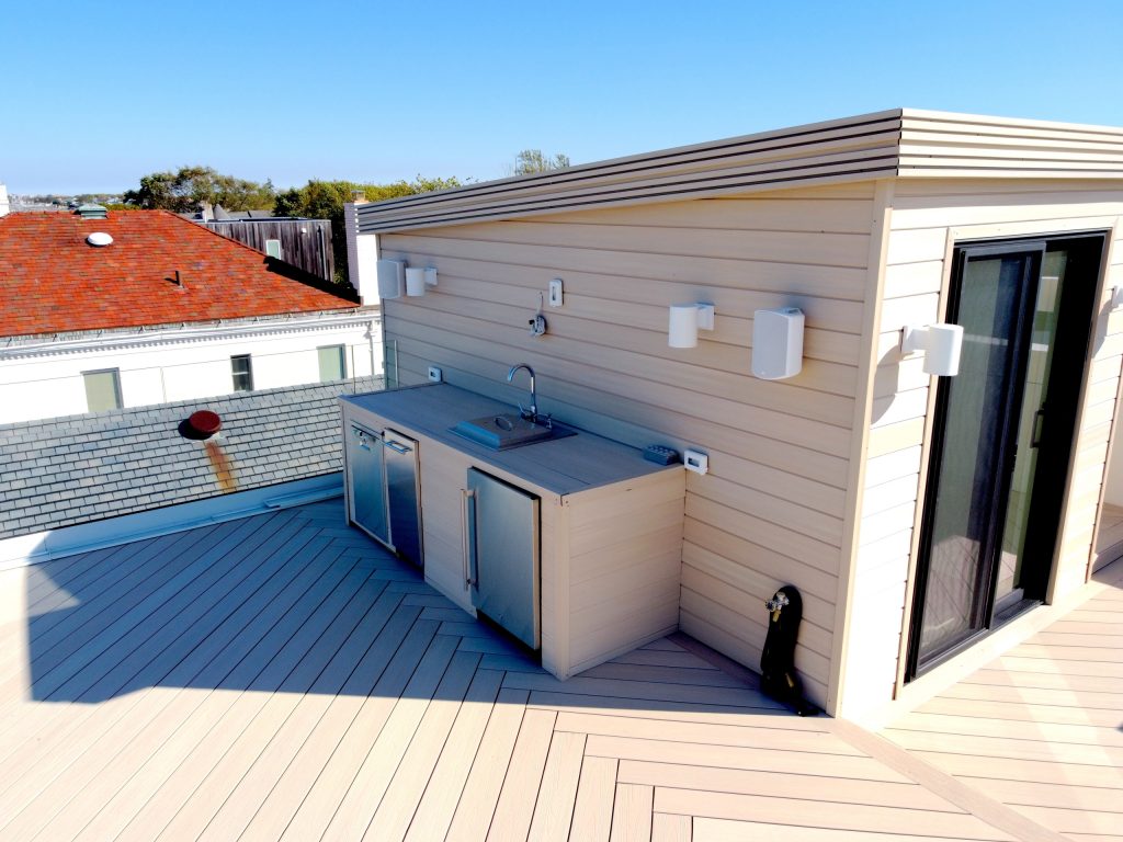 Inspiration for a large modern rooftop rooftop glass railing outdoor kitchen deck remodel in New York with no cover