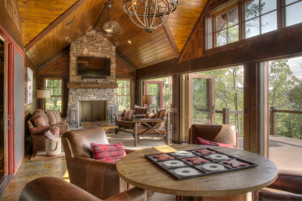 Inspiration for a large rustic back porch remodel in Minneapolis with a fireplace and a roof extension by Lands End Development - Designers & Builders | Outdoor Photos | Porch | Landscaping | Landscape Design | Outdoor Living Space | Porch Design Ideas | Outdoor Living Space Ideas | Backyard Design