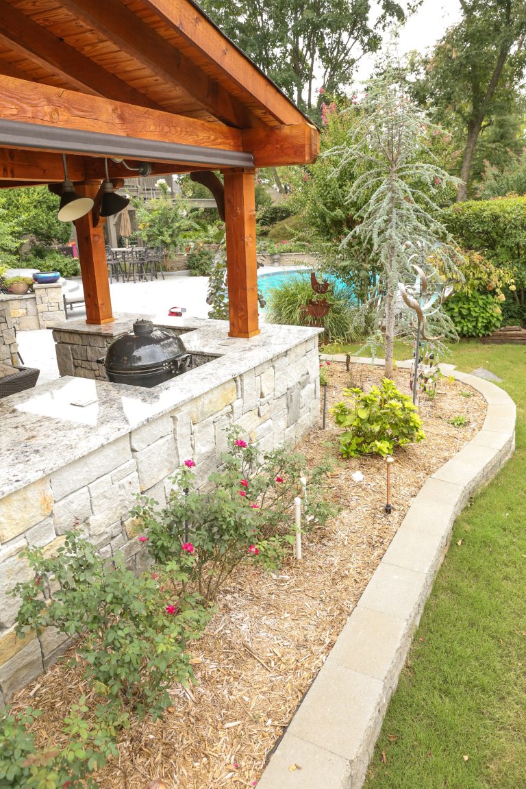 Inspiration for a large rustic backyard concrete patio kitchen remodel in Other with a pergola