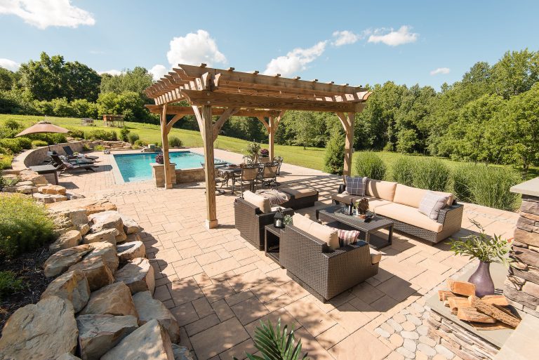 Inspiration for a large rustic backyard concrete paver and rectangular pool remodel in Richmond