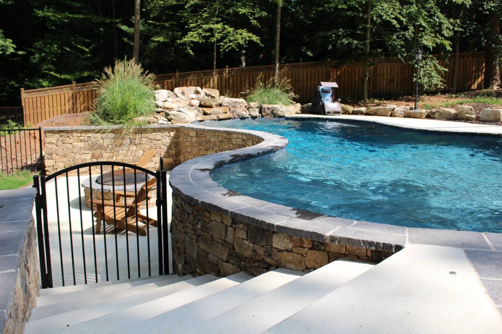 Inspiration for a large rustic backyard custom-shaped natural pool fountain remodel in DC Metro with decking