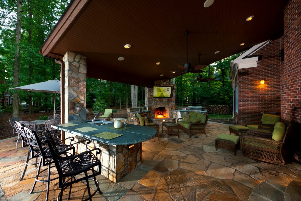 Inspiration for a large rustic backyard stone patio kitchen remodel in Charlotte with a gazebo