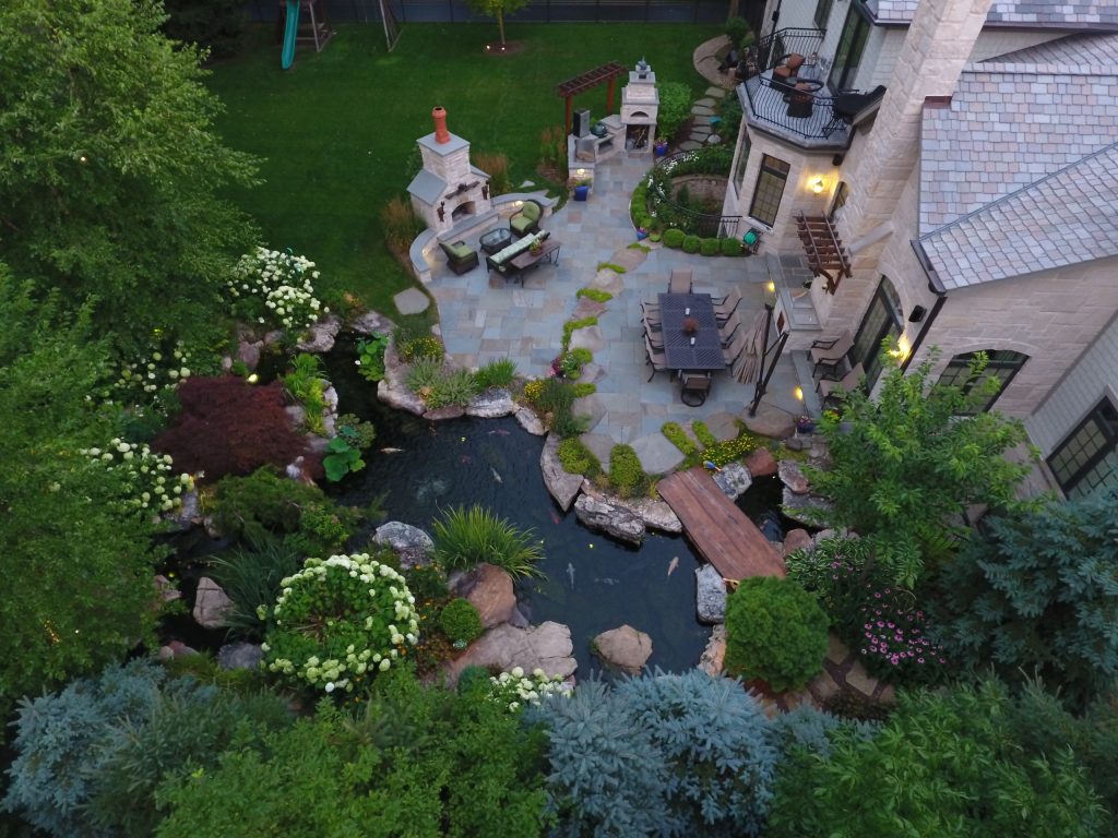 Inspiration for a large rustic backyard stone patio kitchen remodel in Chicago with no cover