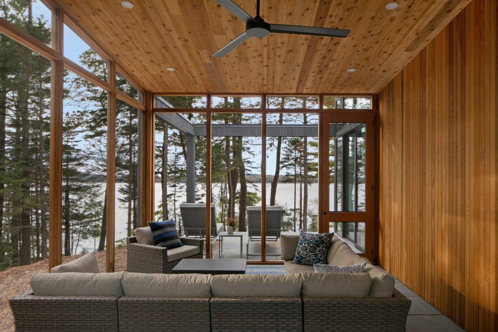 Inspiration for a large rustic concrete paver screened-in side porch remodel in Portland Maine with a roof extension by Acorn Deck House Company | Outdoor Photos | Porch | Landscaping | Landscape Design | Outdoor Living Space | Porch Design Ideas | Outdoor Living Space Ideas | Backyard Design