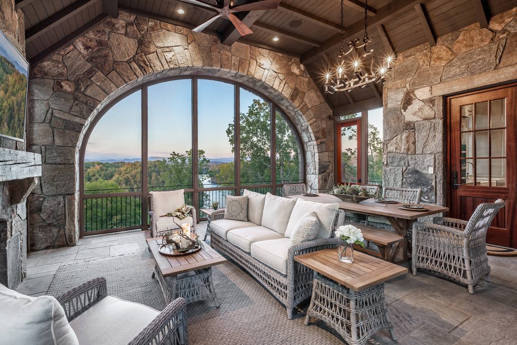 Inspiration for a large rustic stone screened-in side porch remodel in Other with a roof extension by ID Studio Interiors | Outdoor Photos | Porch | Landscaping | Landscape Design | Outdoor Living Space | Porch Design Ideas | Outdoor Living Space Ideas | Backyard Design