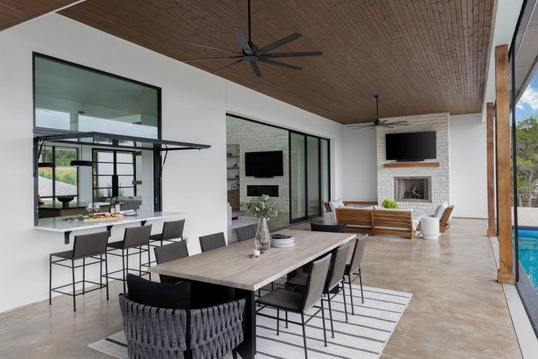 Inspiration for a large scandinavian backyard concrete patio kitchen remodel in Austin with a roof extension