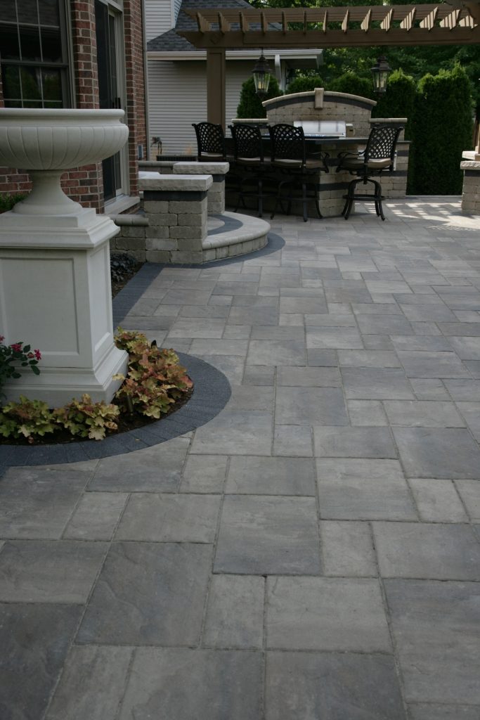 Inspiration for a large timeless backyard brick patio kitchen remodel in Chicago with a pergola