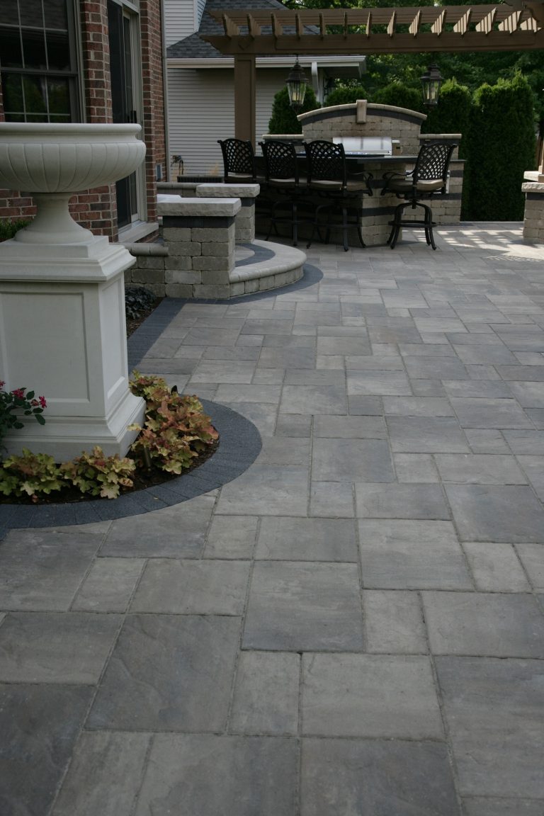 Inspiration for a large timeless backyard brick patio kitchen remodel in Chicago with a pergola