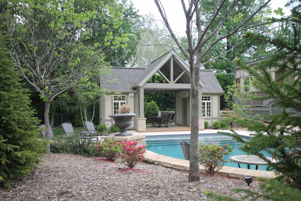 Inspiration for a large timeless backyard concrete and custom-shaped natural pool house remodel in San Diego