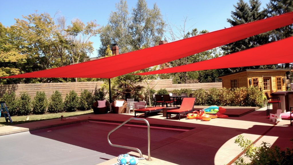 Inspiration for a large timeless backyard concrete patio kitchen remodel in Portland with an awning