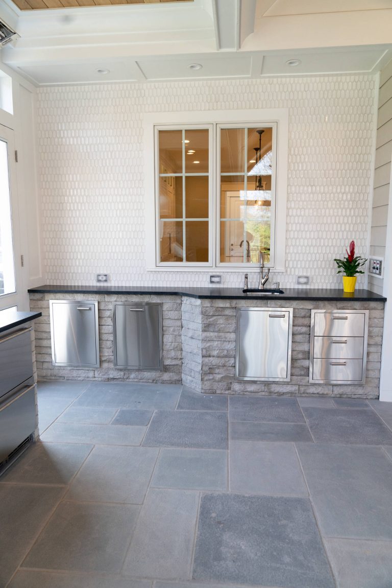 Inspiration for a large timeless backyard concrete paver patio kitchen remodel in DC Metro with a roof extension