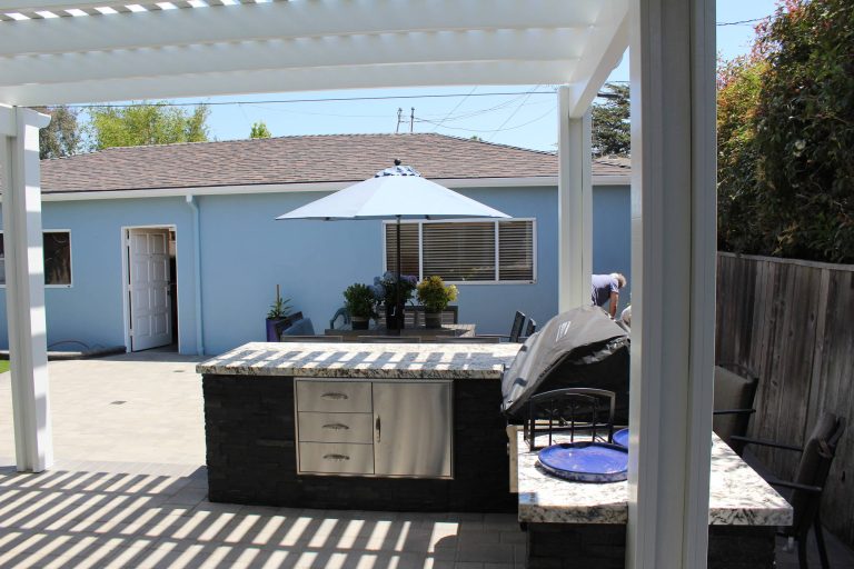 Inspiration for a large timeless backyard concrete paver patio kitchen remodel in Los Angeles with a pergola