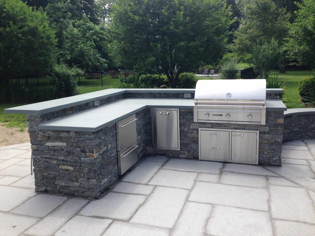 Inspiration for a large timeless backyard concrete paver patio kitchen remodel in New York with no cover