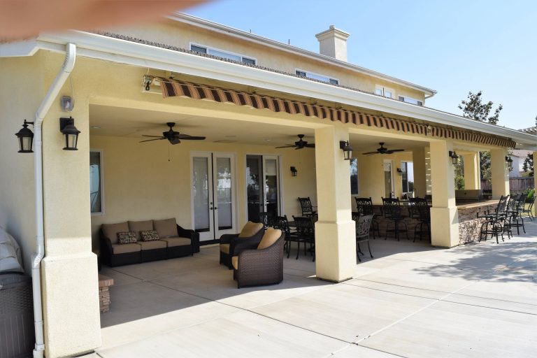 Inspiration for a large timeless backyard concrete paver patio kitchen remodel in Other with a roof extension