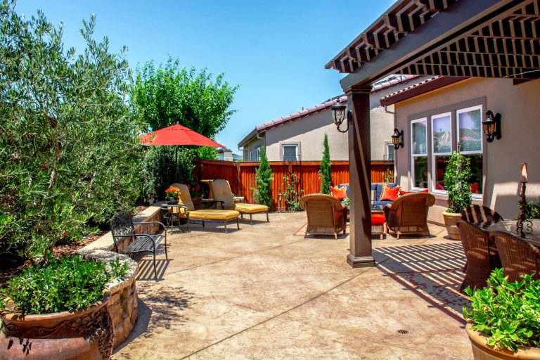 Inspiration for a large timeless backyard concrete paver patio kitchen remodel in San Francisco with a gazebo