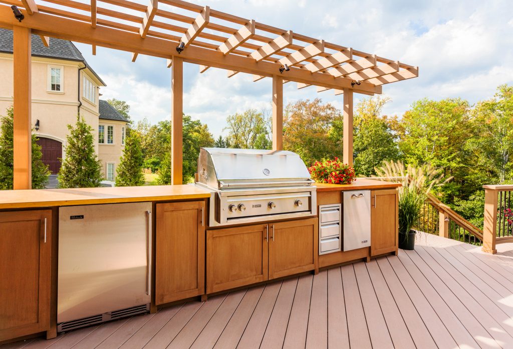 Inspiration for a large timeless backyard outdoor kitchen deck remodel in New York with a pergola