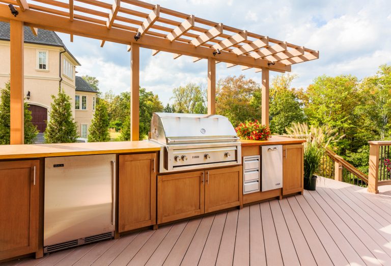 Inspiration for a large timeless backyard outdoor kitchen deck remodel in New York with a pergola