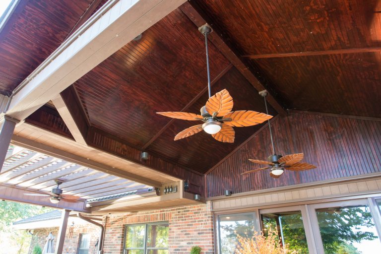 Inspiration for a large timeless backyard stamped concrete patio kitchen remodel in Kansas City with a pergola