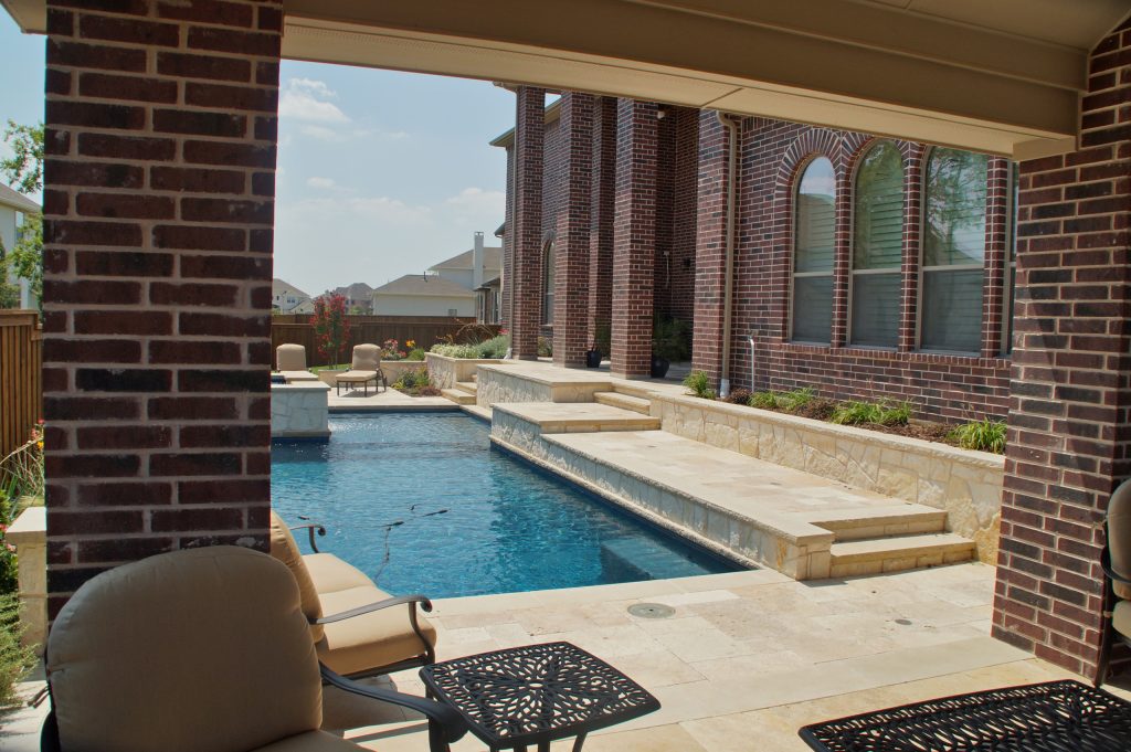 Inspiration for a large timeless backyard stone and rectangular lap pool fountain remodel in Dallas