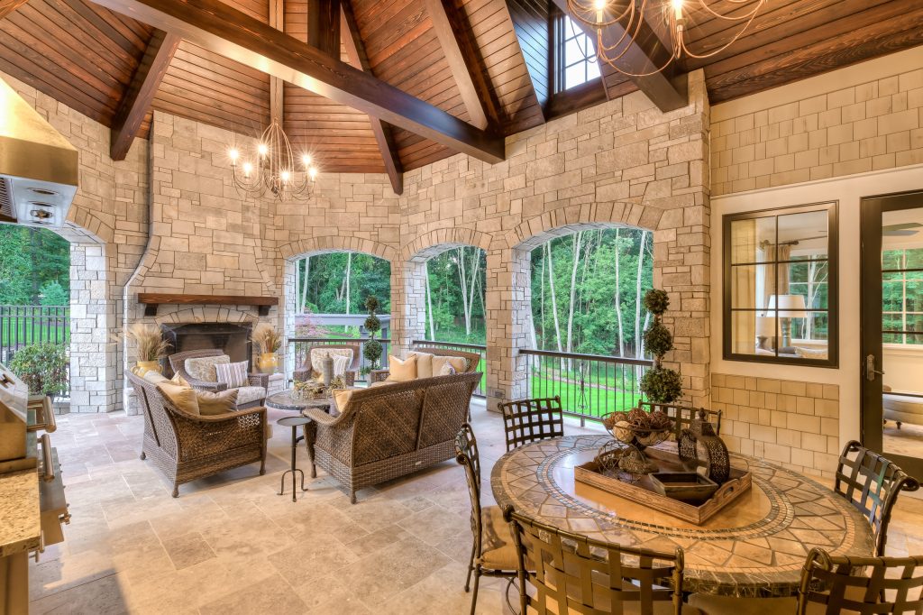 Inspiration for a large timeless backyard stone patio kitchen remodel in Grand Rapids with a gazebo