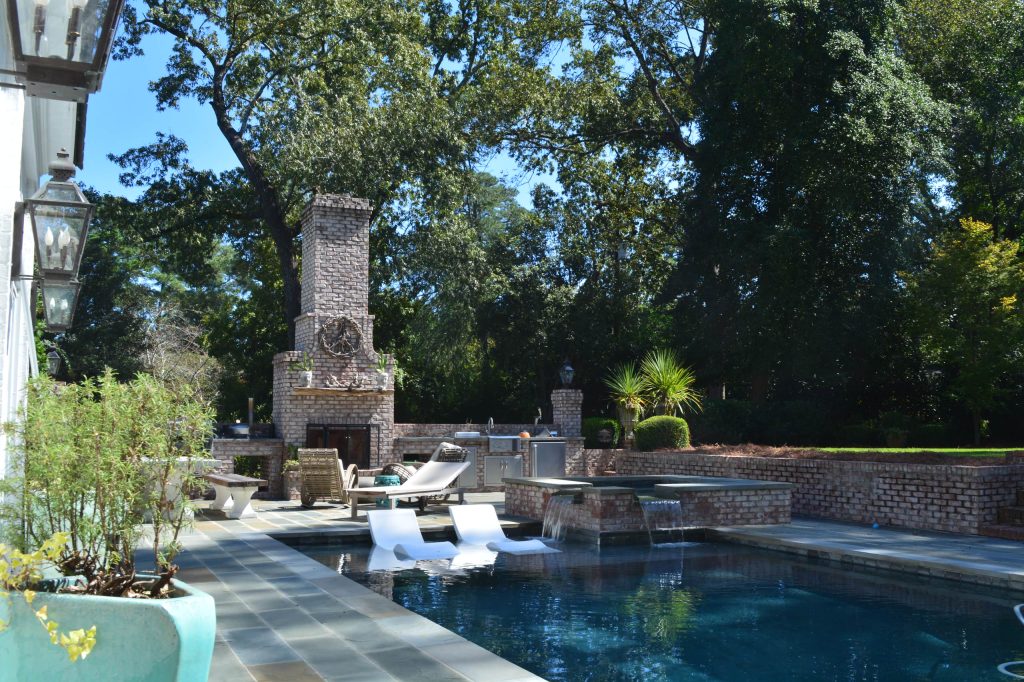 Inspiration for a large timeless backyard stone patio kitchen remodel in Other with no cover