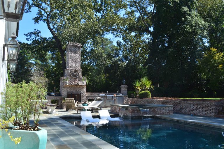 Inspiration for a large timeless backyard stone patio kitchen remodel in Other with no cover