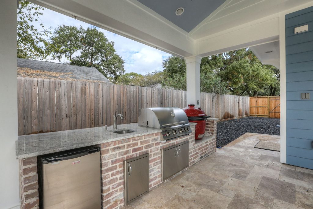 Inspiration for a large timeless backyard tile patio kitchen remodel in Houston with a roof extension