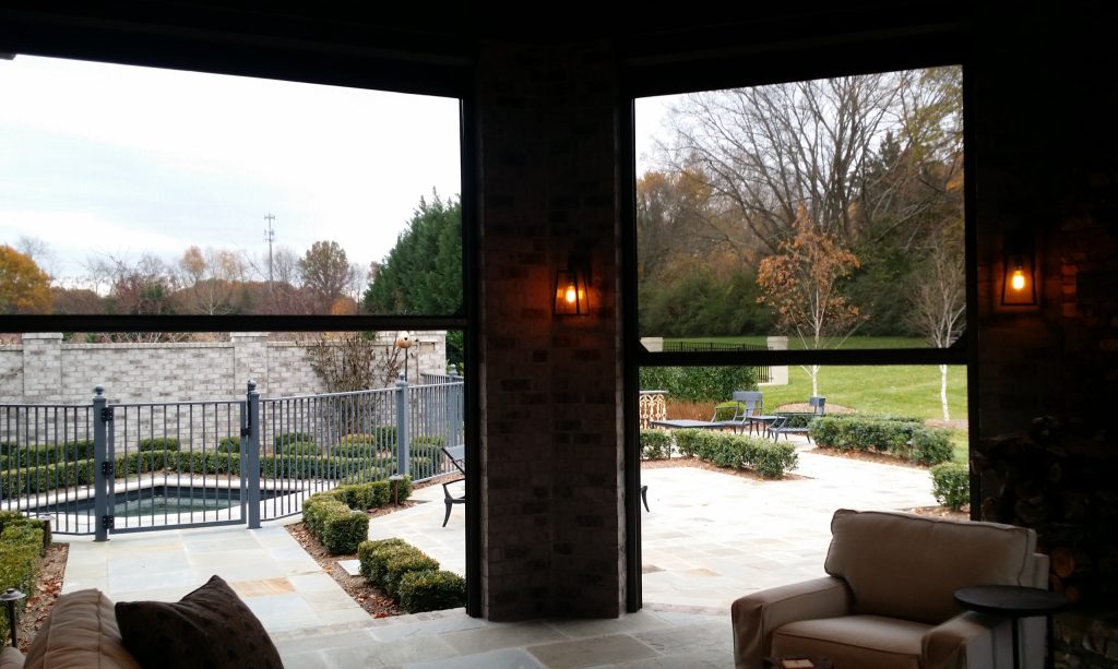 Inspiration for a large timeless backyard tile patio kitchen remodel in Orange County with a roof extension