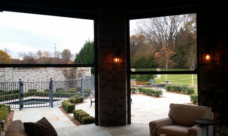 Inspiration for a large timeless backyard tile patio kitchen remodel in Orange County with a roof extension