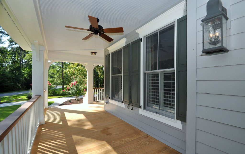 Inspiration for a large timeless front porch remodel in Charleston with a roof extension by Great Southern Builders LLC | Outdoor Photos | Porch | Landscaping | Landscape Design | Outdoor Living Space | Porch Design Ideas | Outdoor Living Space Ideas | Backyard Design