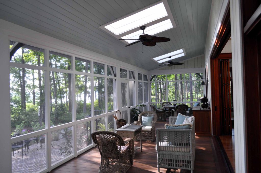 Inspiration for a large timeless screened-in back porch remodel in Atlanta with decking and a roof extension by Frederick + Frederick Architects | Outdoor Photos | Porch | Landscaping | Landscape Design | Outdoor Living Space | Porch Design Ideas | Outdoor Living Space Ideas | Backyard Design