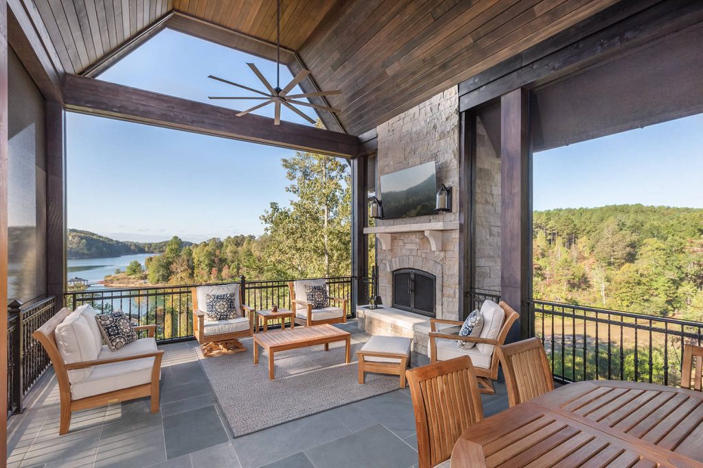 Inspiration for a large timeless stone back porch remodel in Other with a fire pit and a roof extension by ID Studio Interiors | Outdoor Photos | Porch | Landscaping | Landscape Design | Outdoor Living Space | Porch Design Ideas | Outdoor Living Space Ideas | Backyard Design