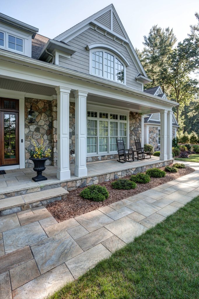 Inspiration for a large timeless stone front porch remodel in Boston with a roof extension by Laplante Construction Inc. | Outdoor Photos | Porch | Landscaping | Landscape Design | Outdoor Living Space | Porch Design Ideas | Outdoor Living Space Ideas | Backyard Design