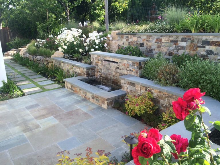 Inspiration for a large traditional full sun backyard stone retaining wall landscape in Other for summer.