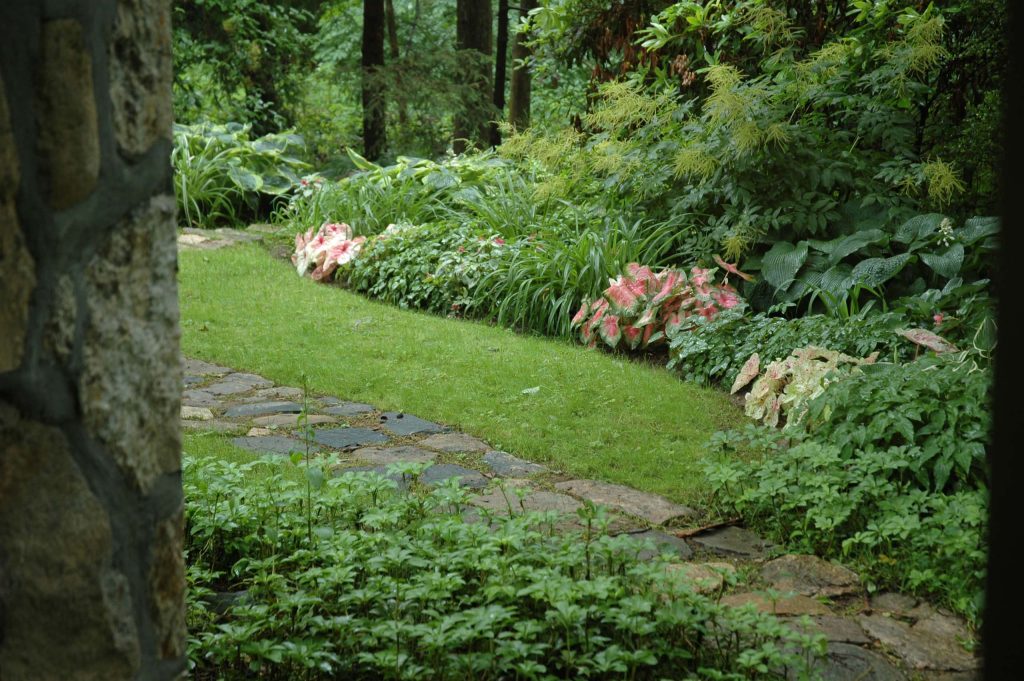 Inspiration for a large traditional partial sun backyard stone garden path in New York.