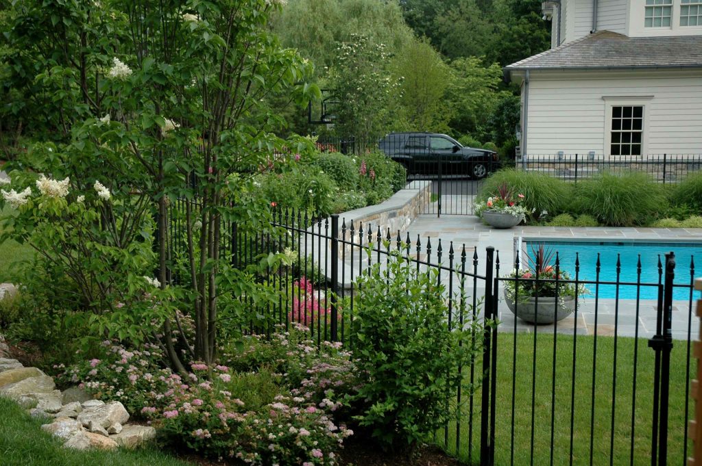 Inspiration for a large traditional partial sun backyard stone water fountain landscape in New York.