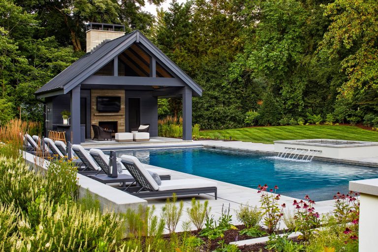 Inspiration for a large transitional backyard concrete paver and rectangular pool house remodel in DC Metro