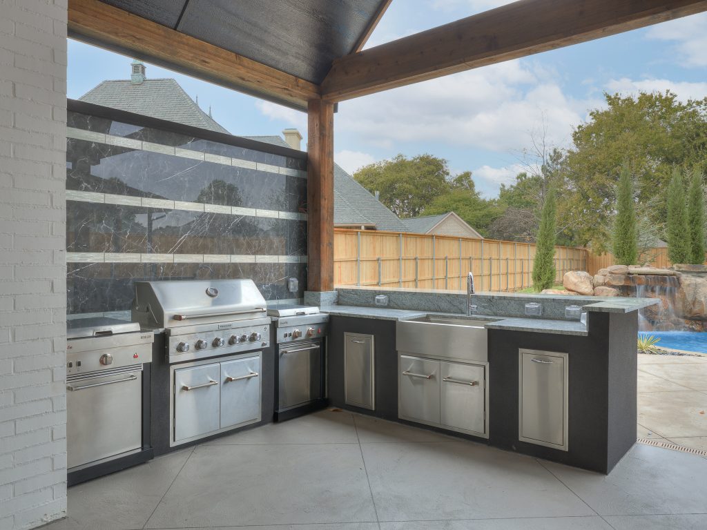 Inspiration for a large transitional backyard patio kitchen remodel in Oklahoma City with a roof extension