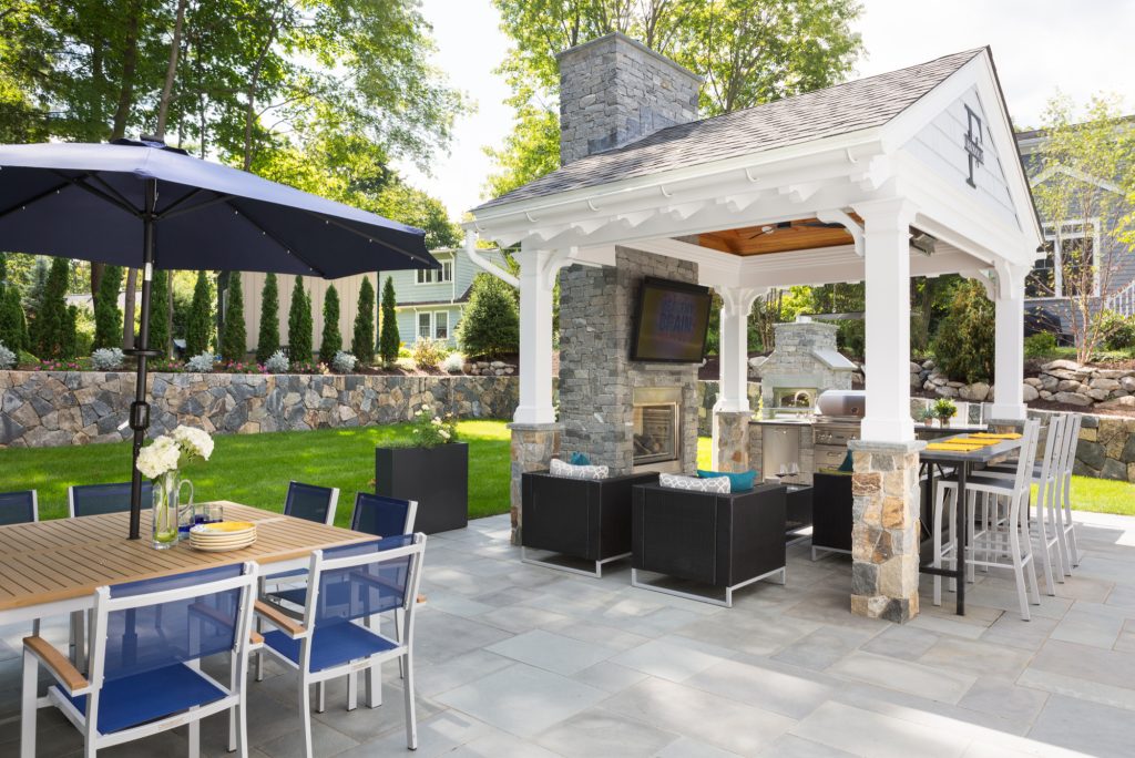 Inspiration for a large transitional backyard stone patio kitchen remodel in Boston with a gazebo